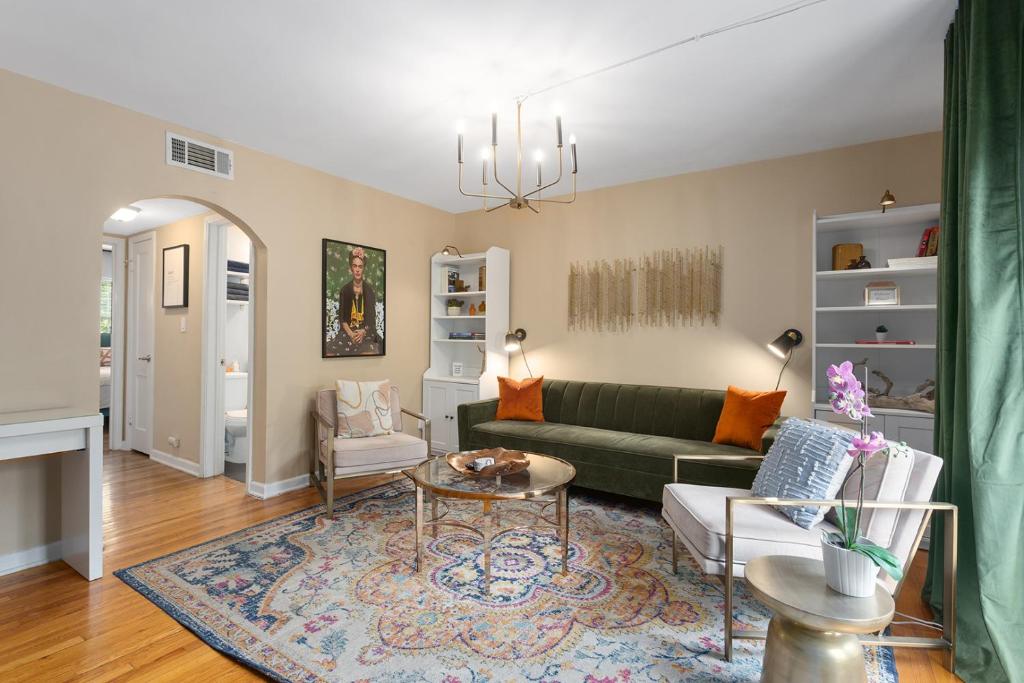 a living room with a green couch and a table at Plaza Condo With Queen Bed 3 in Kansas City