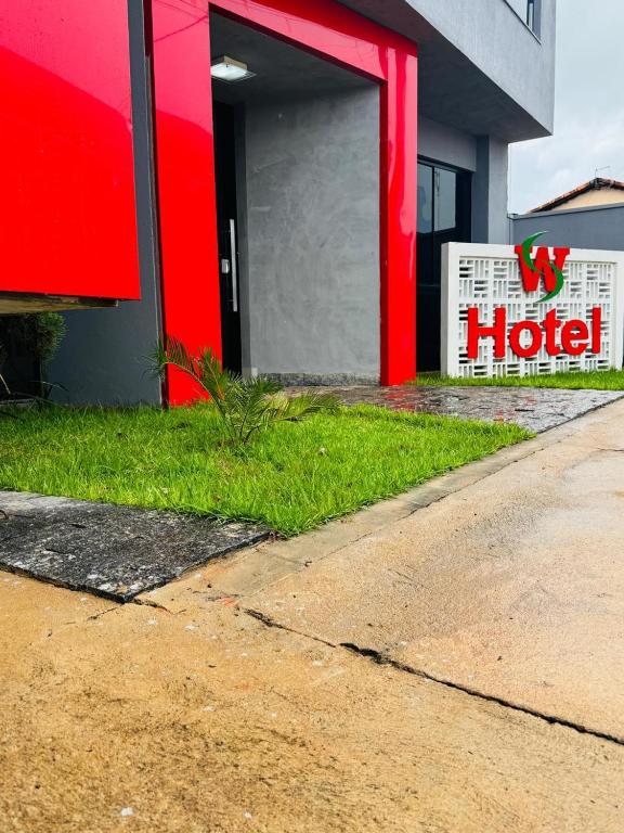 a hotel sign on the side of a building at WS Hotel in Campo Alegre
