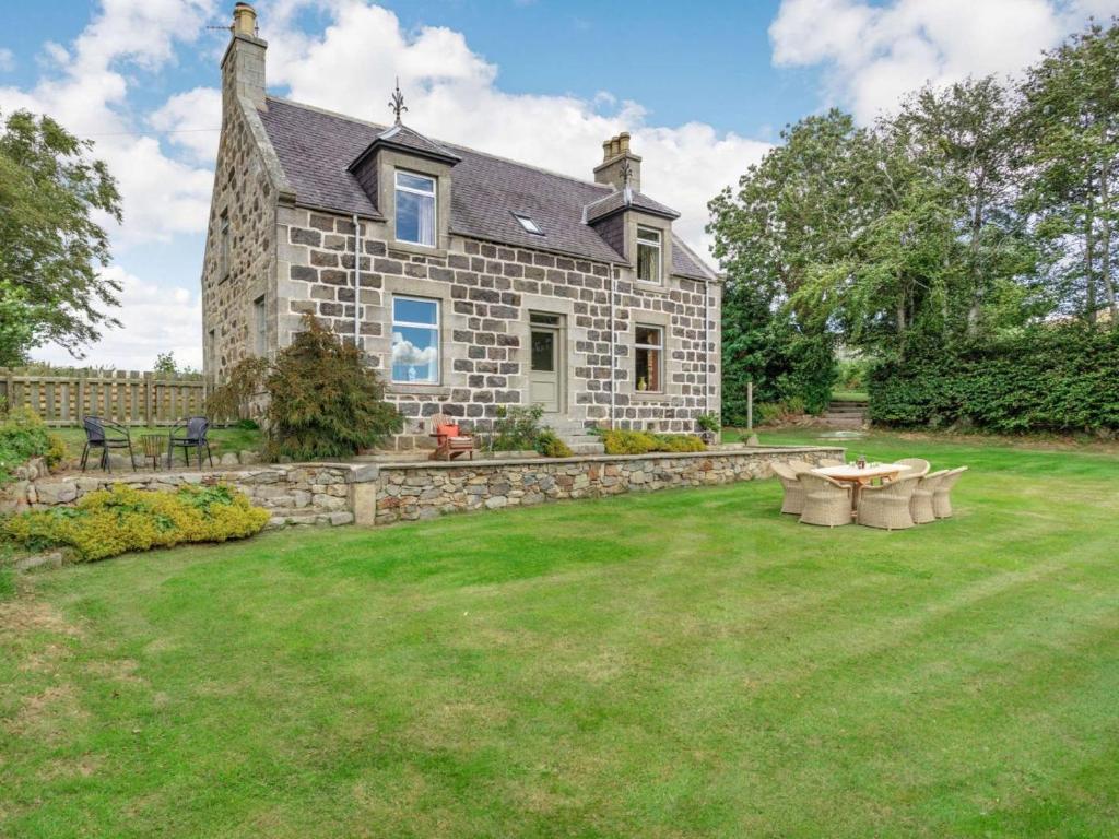 a stone house with a lawn in front of it at 4 Bed in Huntly oc-88855 in Inverurie