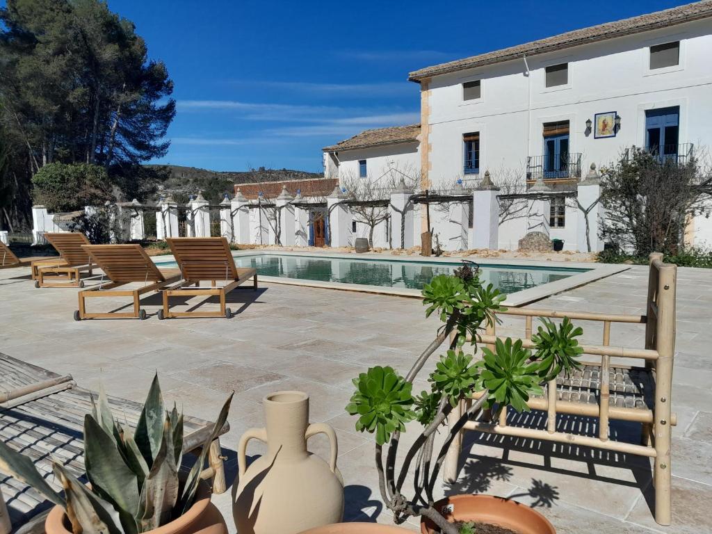 a courtyard with chairs and a swimming pool at Rosie's Garden in Bocairent
