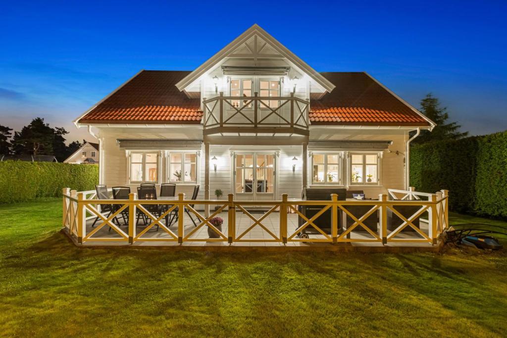 a house with a large deck in front of it at Big villa with outbuilding in Sarpsborg