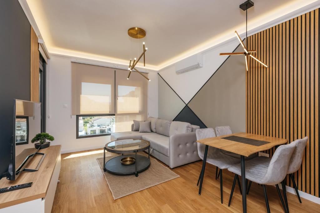 a living room with a couch and a table at Luxury Apartment Bar in Šušanj
