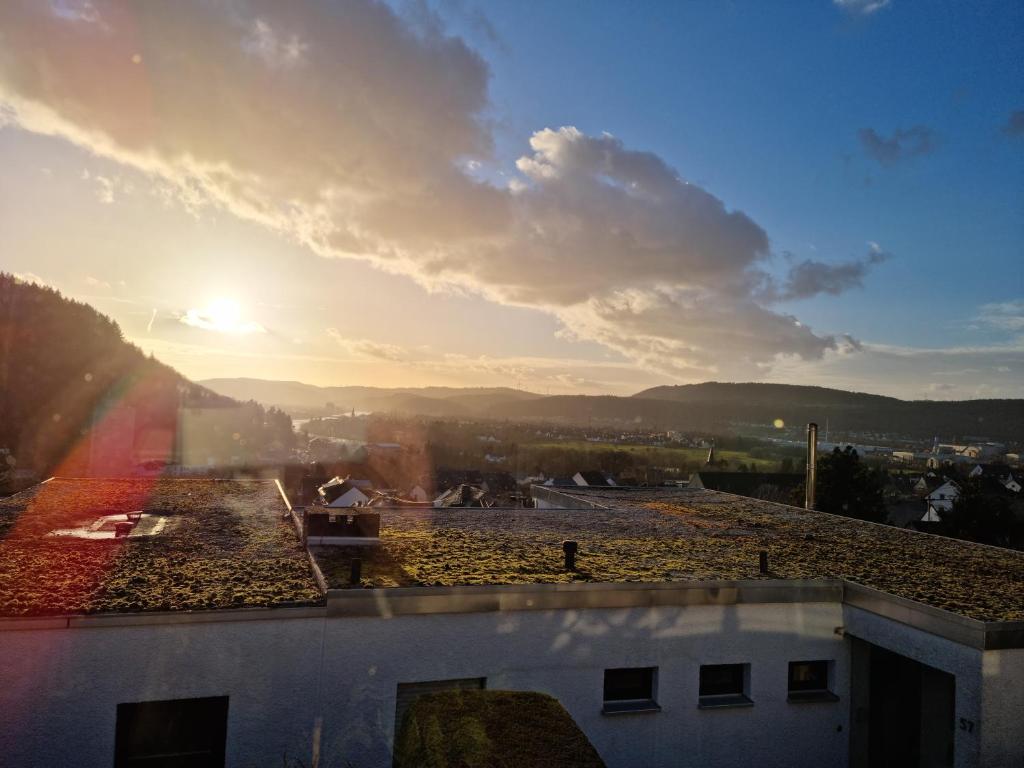 a view of the sunset from the roof of a building at RUWERA SONNENHÜGEL - Moderne Ferienwohnung - eigener Eingang, Garten und Terrasse in Trier
