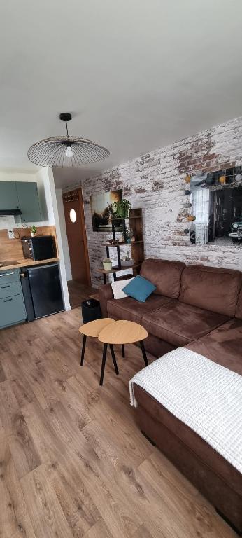 a living room with a couch and a table at Charmant studio in Vernon