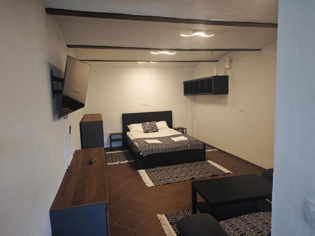 a room with a bed and a table in it at Apartmaji pr'Muranček in Radovljica