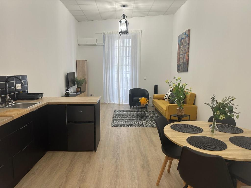 a kitchen and living room with a table and chairs at Apartamento Vinoble Jerez in Jerez de la Frontera