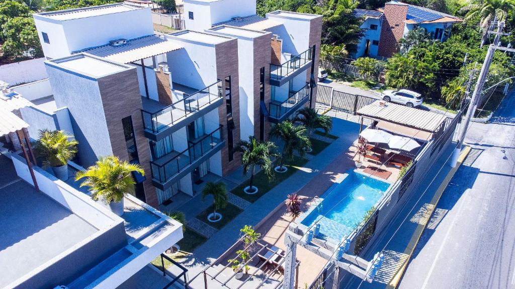 an aerial view of a house with a swimming pool at Altos do Caju - Triplex in Pirangi 300 meters from the World's Largest Cashew Tree by Carpediem in Parnamirim