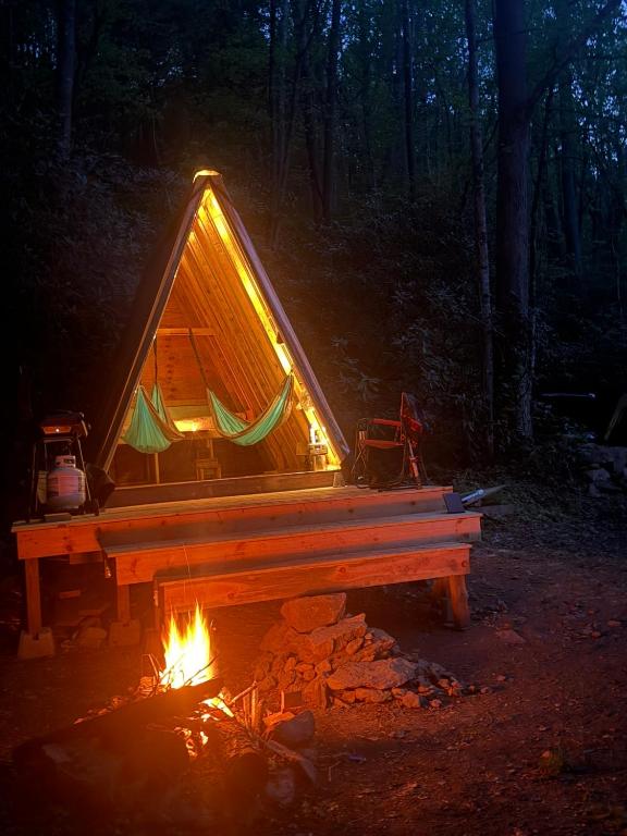 a tent with a fire in front of it at The Outside Inn in Cullowhee