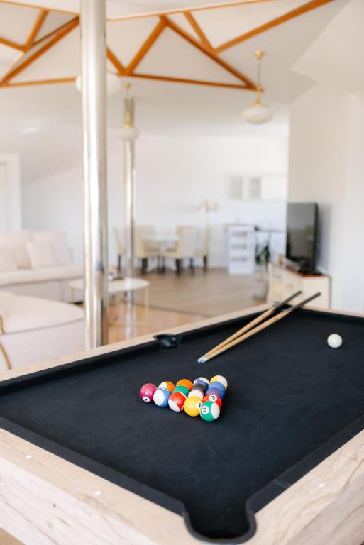 a pool table with cue balls on top of it at Villa Cetatuia in Cluj-Napoca
