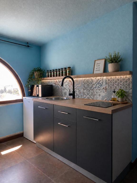 a kitchen with a sink and a counter at Casa Ombrina in Orosei