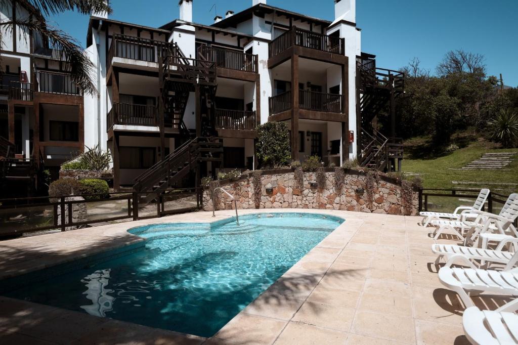a swimming pool in front of a building at Villa Ostende Apart Hotel & Spa in Ostende