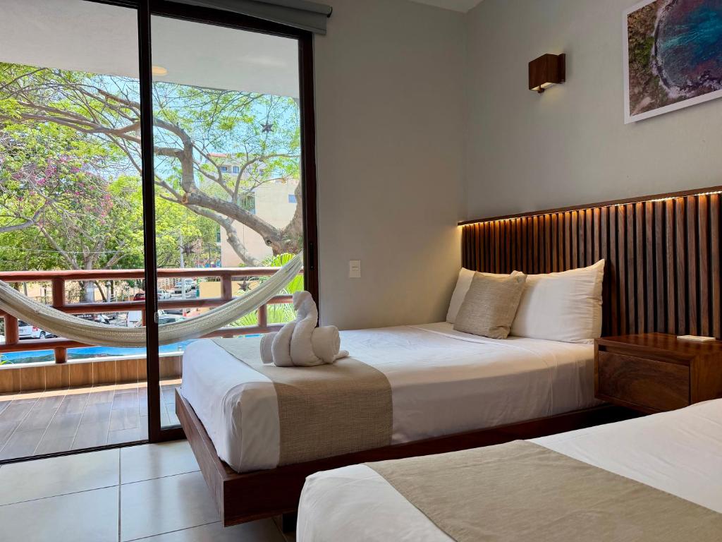 Una cama o camas en una habitación de Hotel Aldea Sol