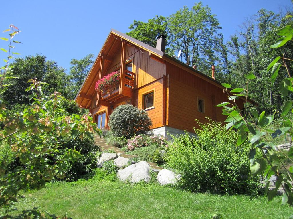 a small wooden house with a balcony at Chalet Les Genêts 2 - Spa et Sauna in Saint-Amarin