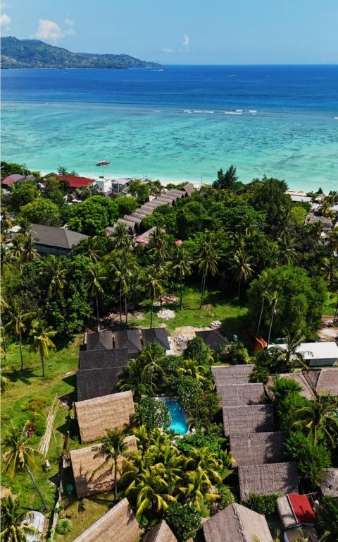 an aerial view of a resort near the ocean at Lucy's Garden Hotel in Gili Islands