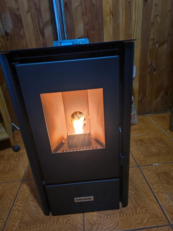a fire in a fireplace in a room at Cabaña 4 personas in Coñaripe