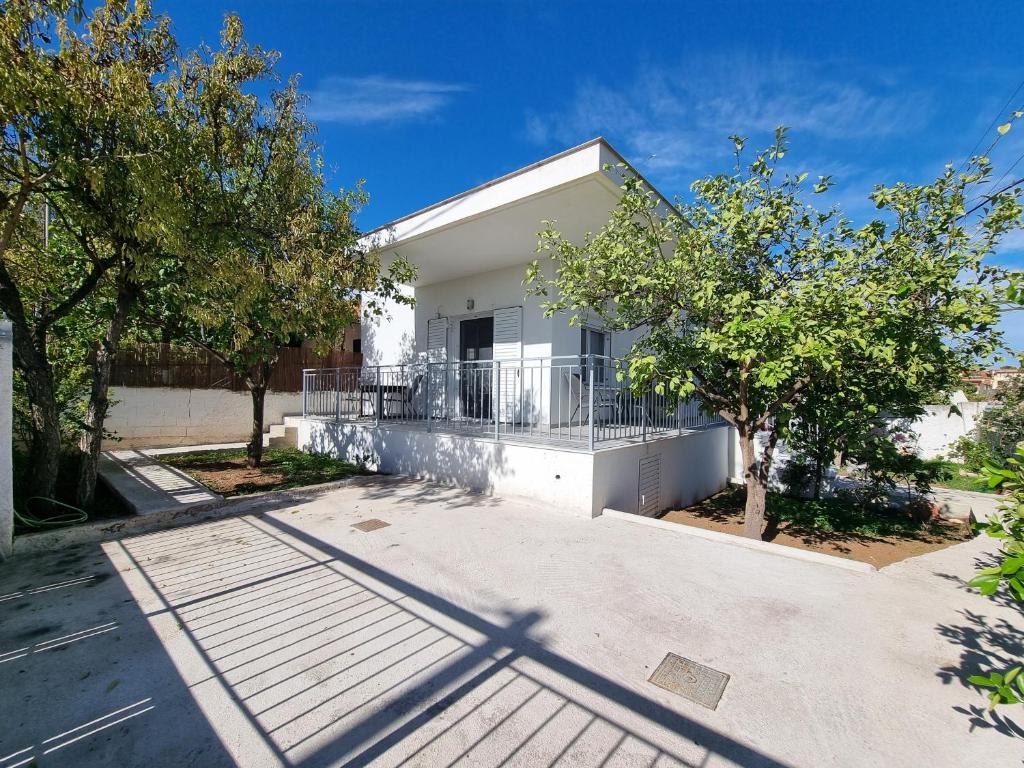 a white house with trees in front of it at Mentis Home in Artemida