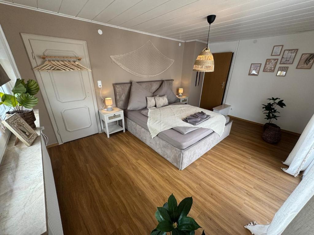 a bedroom with a bed and a wooden floor at BOHO Apartment Skye in Bad Reichenhall