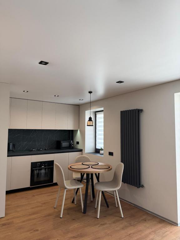 a kitchen with a table and chairs in a room at NV Apartments 2 in Volodymyr-Volynskyi
