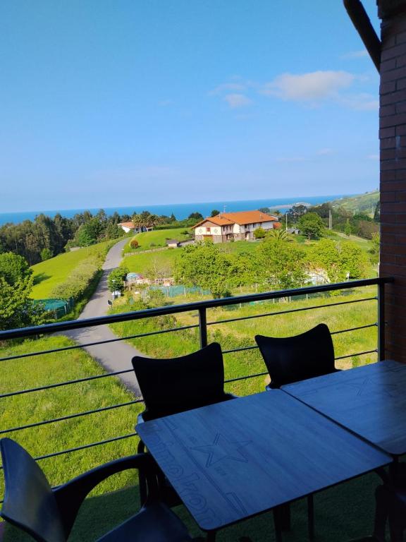 a blue table on a balcony with a view of the ocean at Gure Bidetxe in San Andrés