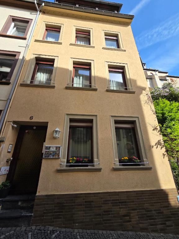 a building with three windows with flowers in them at Haus Sofia in Cochem