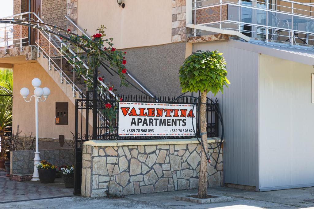 a sign on the side of a building at Apartments Valentinaa in Gevgelija