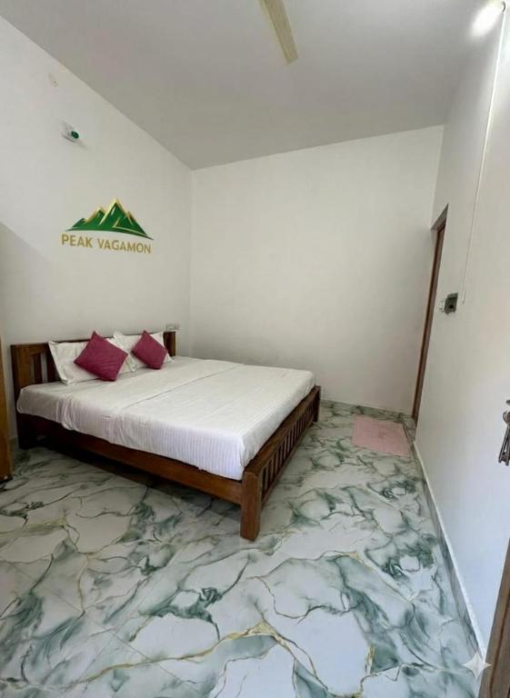 a bedroom with a bed and a rug at Peak Vagamon in Vagamon
