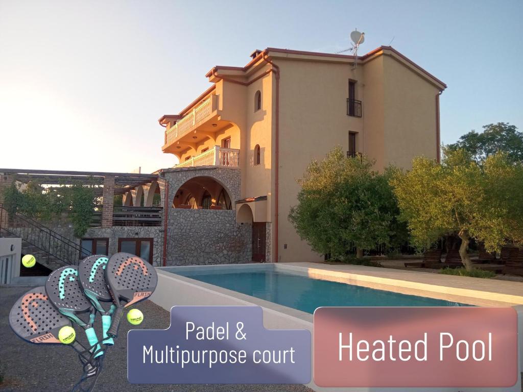 a villa with a swimming pool and a house at B&B Tonivale - Heated Pool, Padel & Meeting Room in Skrbčići