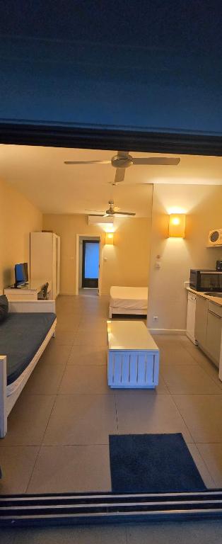 a large room with two beds and a kitchen at Cosy Holidays in Trou aux Biches