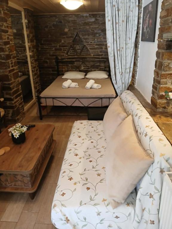 a living room with two beds and a couch at villa lena πετρινο in Katákoilos