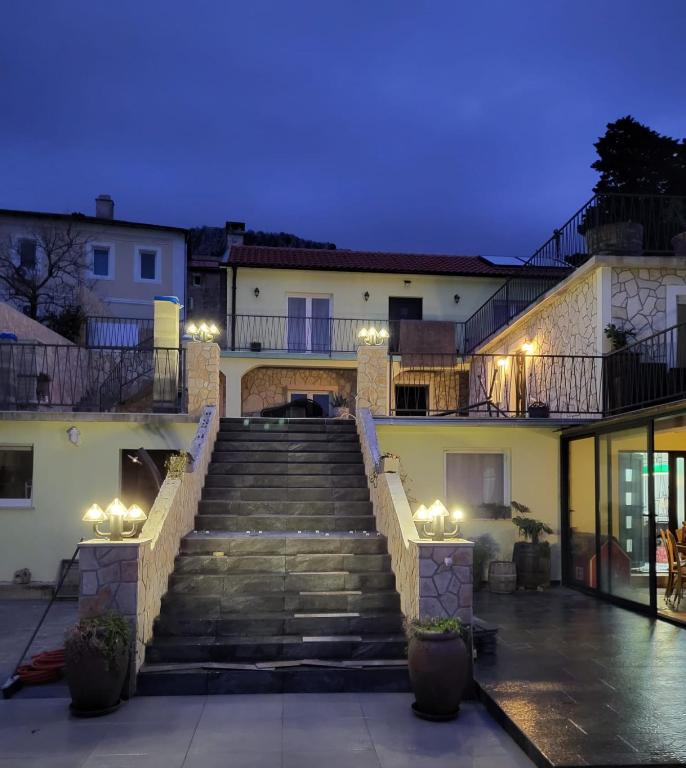 a set of stairs leading up to a building at night at Apartmani Lea in Bribir