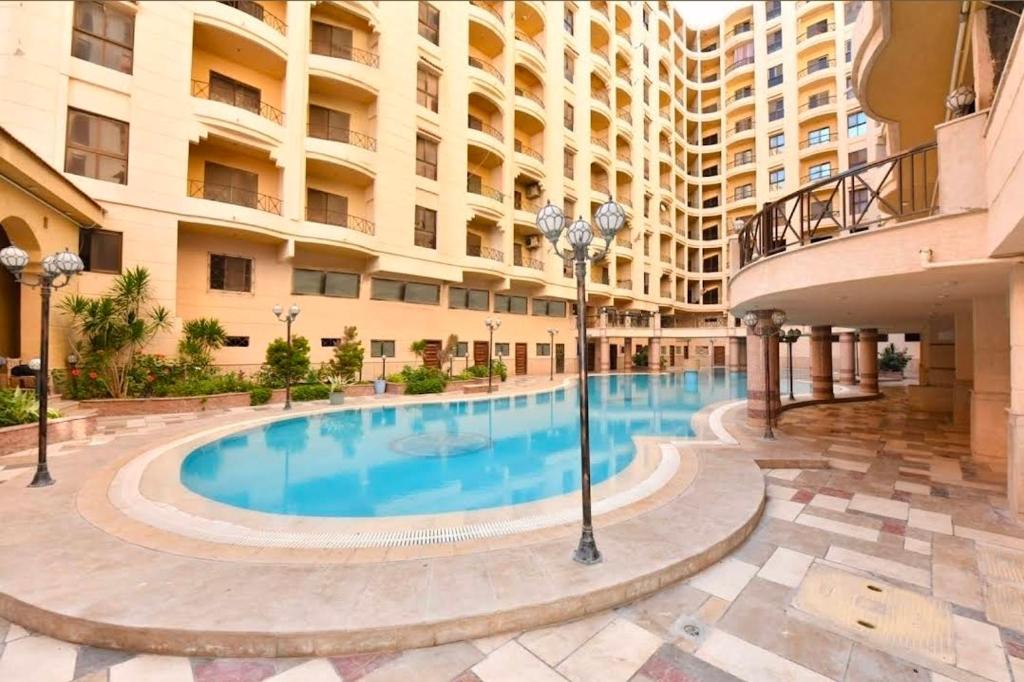 a large swimming pool in the middle of a building at Green View Compound Apartment in Alexandria