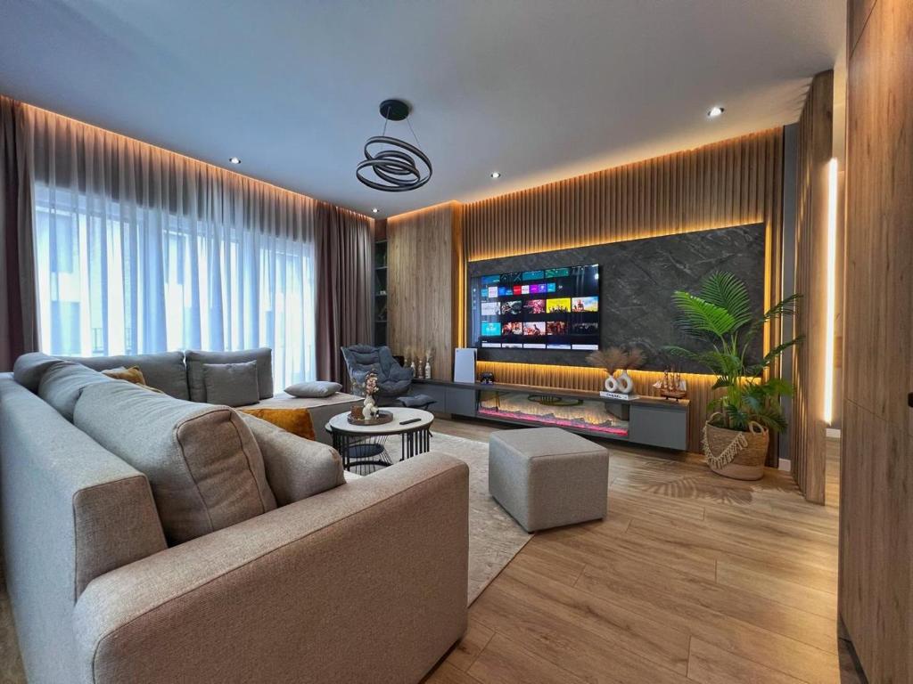 a living room with a couch and a flat screen tv at Luxury Apartment in Shkodër