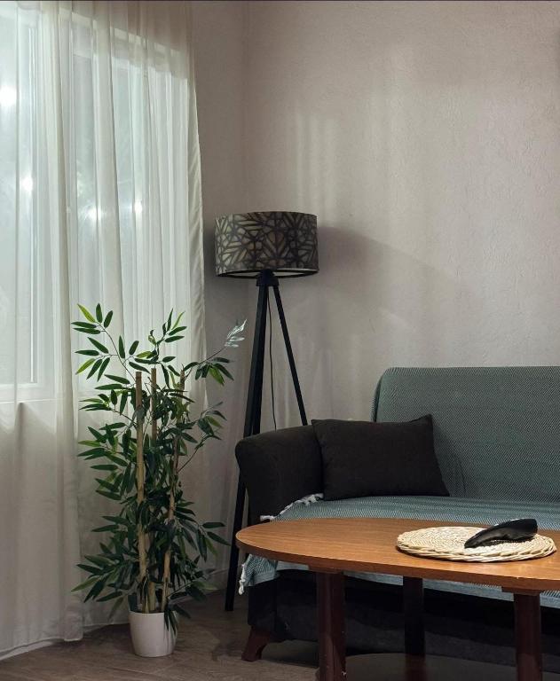 a living room with a couch and a table and a lamp at Cozy cottage in Biisi in Biisi