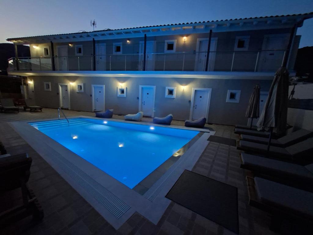 ein Schwimmbad vor einem Gebäude bei Nacht in der Unterkunft george studios 2 in Ýpsos