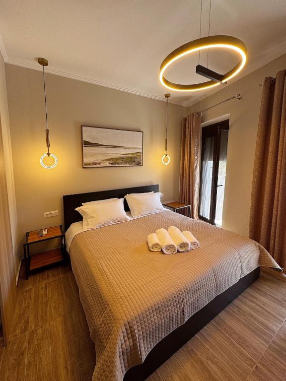 a bedroom with a bed with two towels on it at Gregory Central Apartment in Chania