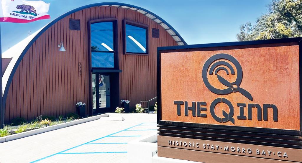 a sign in front of a building with a sign at The Q Inn in Morro Bay
