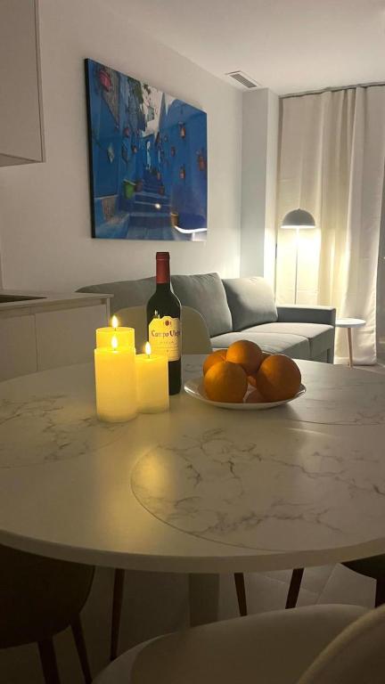 a table with a bottle of wine and two candles at Marina Luxury in Torrevieja