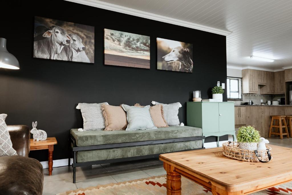 a living room with a couch and a table at Melk en Heuning Uitspan in Orania
