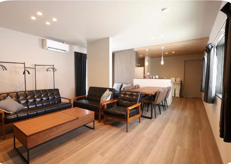 a living room with a couch and a table at Unite in Myoko in Taguchi