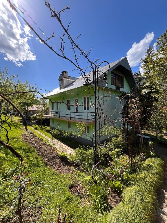 a green house in the middle of a yard at Rest house Keda in K'eda