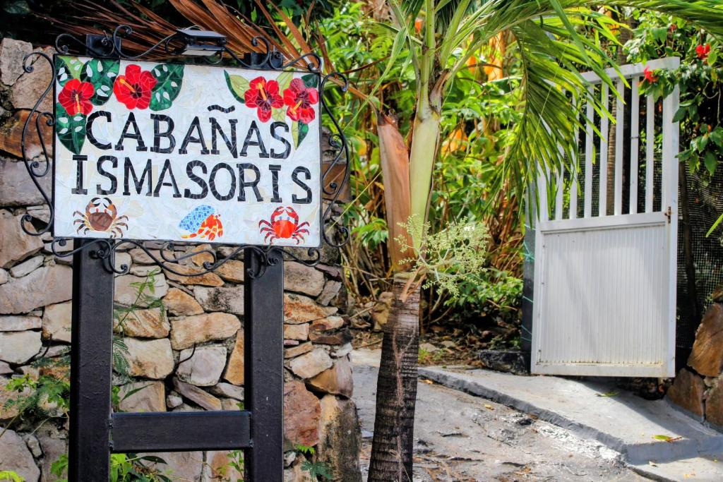 a sign for aaciendas is ambassadors in front of a fence at Cabañas Ismasoris in Providencia