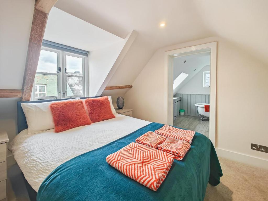 a bedroom with a bed with two pillows on it at 4 Bed in Lymington oc-c41423 in Lymington