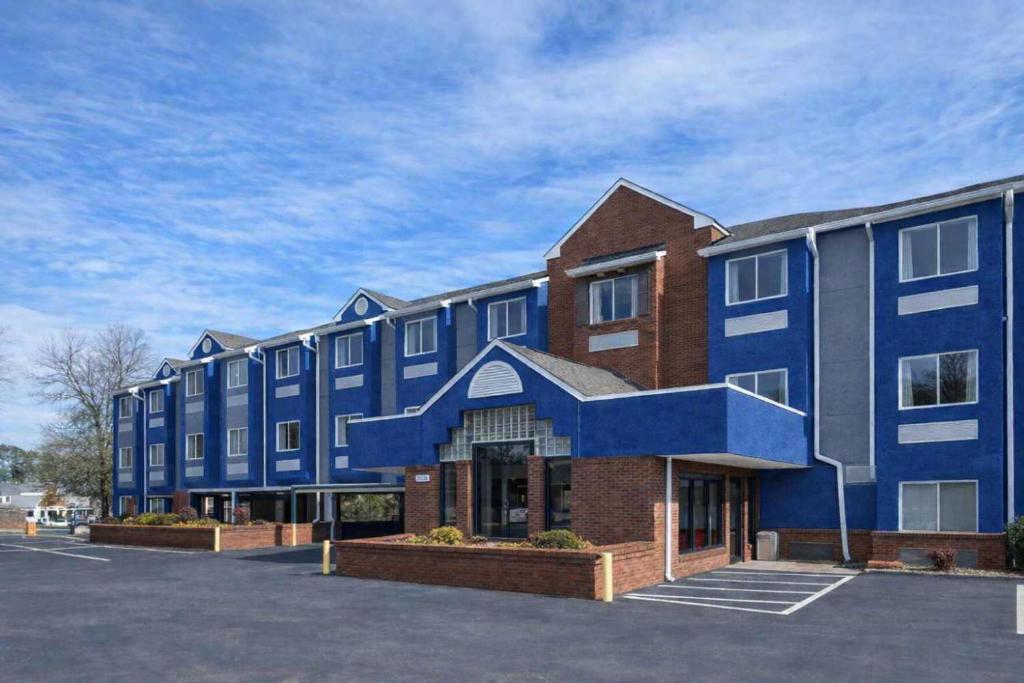 a large blue building with a parking lot at Microtel Inn by Wyndham Lake Norman in Cornelius