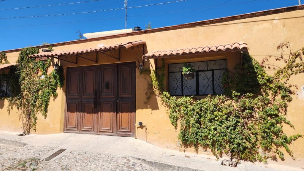 a building with a door and ivy on it at Posada Las Reynas in Mineral de Pozos