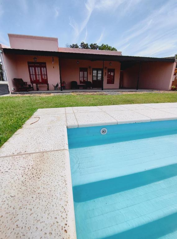 a house with a swimming pool in front of it at Casona Villa Helena in Miramar