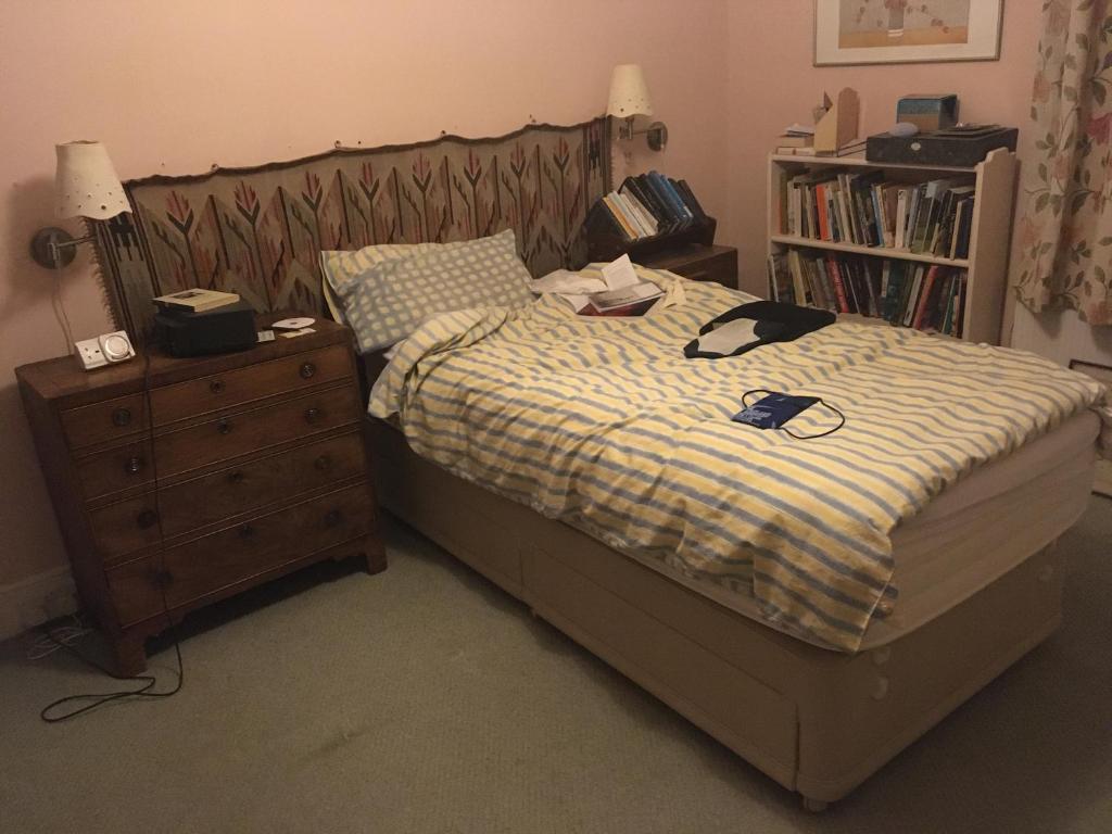 a bedroom with a bed with a dresser and a bed sidx sidx at private room in Leamington Spa