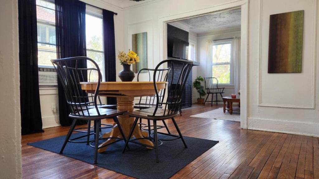 a dining room with a table and four chairs at This Old House in Detroit