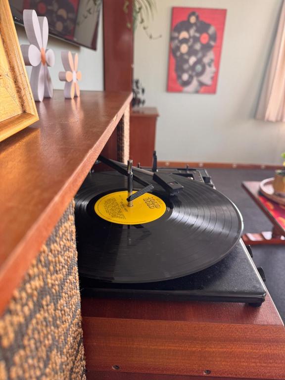 a black vinyl record sitting on top of a counter at Club Retro in Hawera