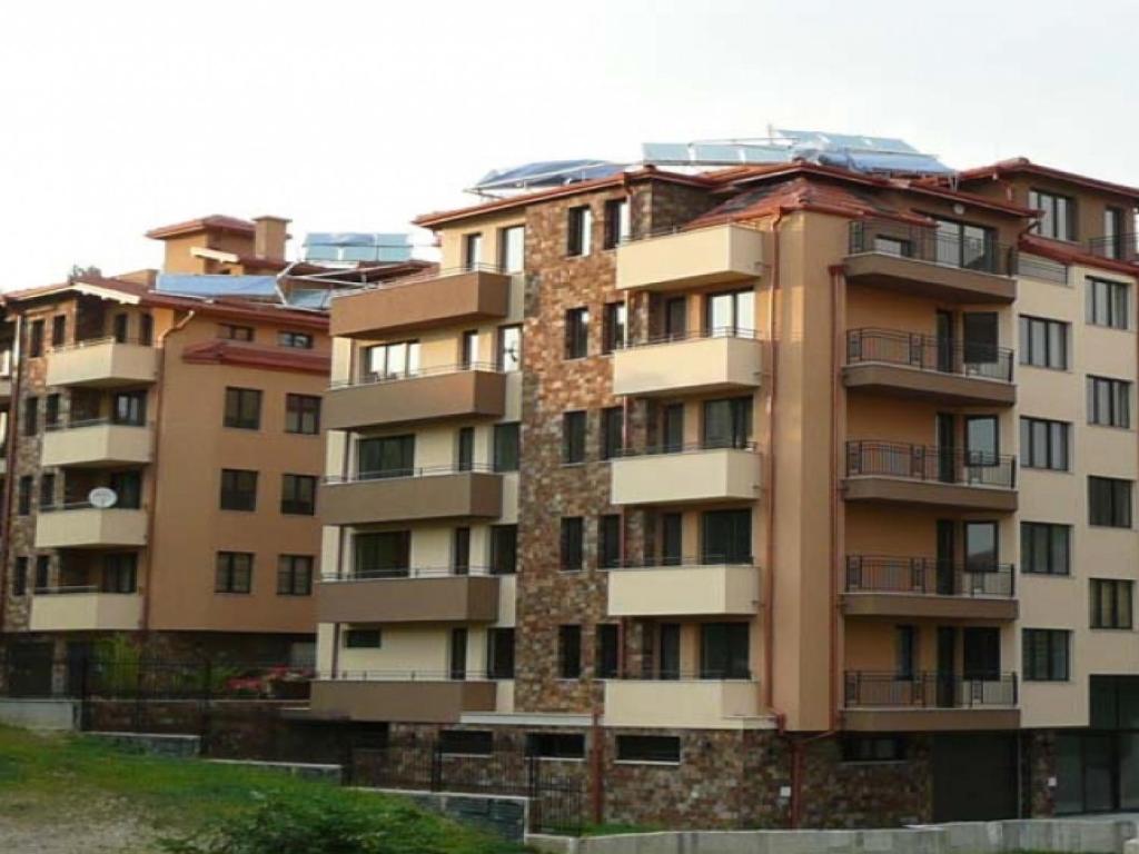 a tall apartment building with balconies on it at Ayberk Apart Sandanski in Sandanski