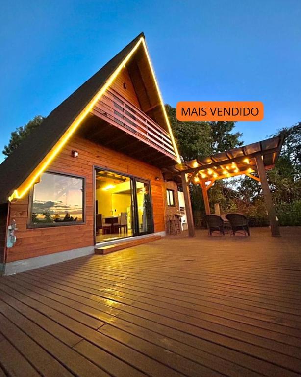 a house with a deck with lights on it at Morada Sunset in Imaruí